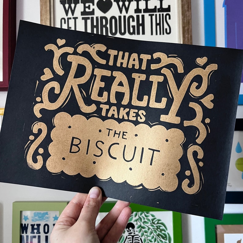 That takes the biscuit linocut print Gold on Black