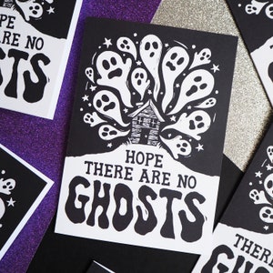 May include: Black and white greeting card with a house surrounded by ghosts. The text reads "Hope there are no ghosts".