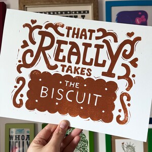 That takes the biscuit linocut print Chocolate Brown