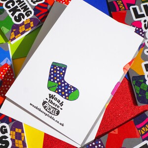 May include: A white card with a colorful sock illustration and the text "Woah there - pickle" and "woahtherepickle.co.uk".