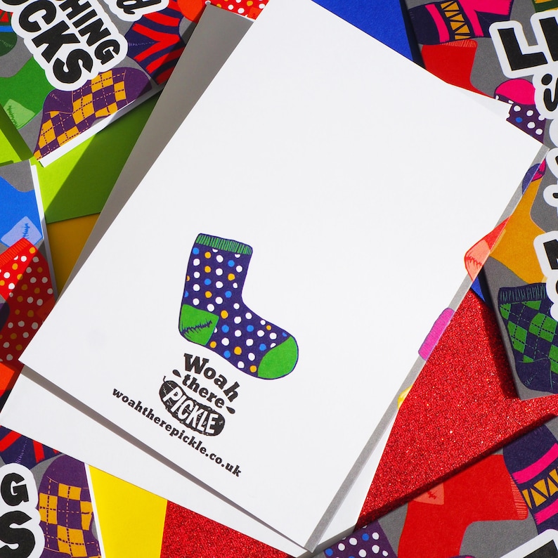 May include: A white card with a colorful sock illustration and the text "Woah there - pickle" and "woahtherepickle.co.uk".
