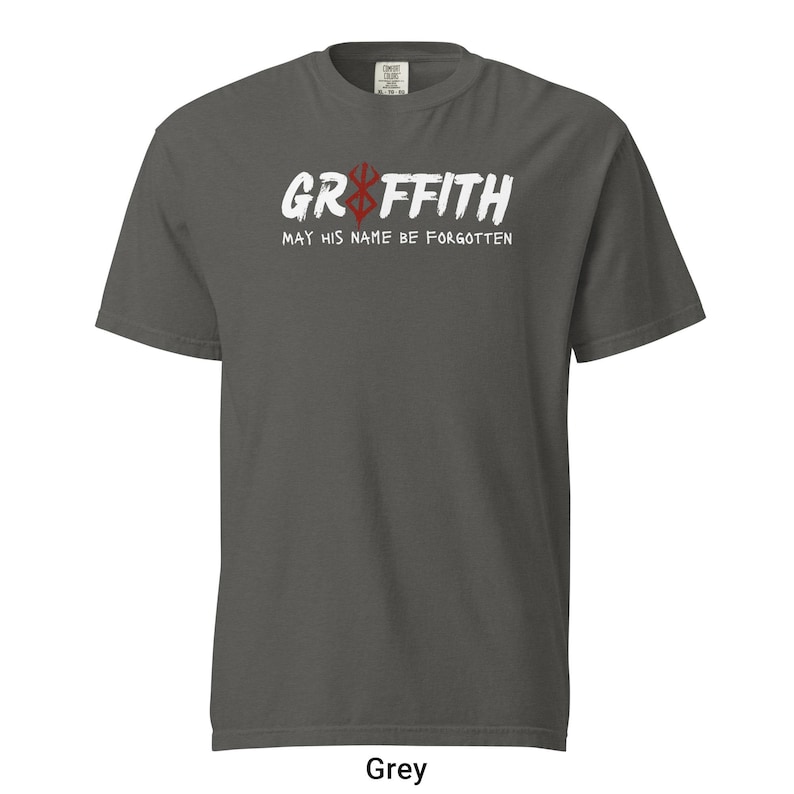 May include: A grey t-shirt with a white graphic print that says "Griffith" with a red and black symbol above the text. The text below the symbol says "May his name be forgotten".