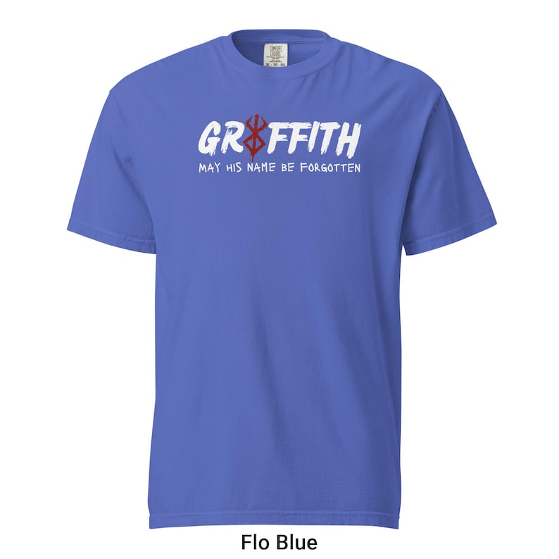 May include: A blue t-shirt with white text that reads "Griffith May His Name Be Forgotten" and a red symbol.