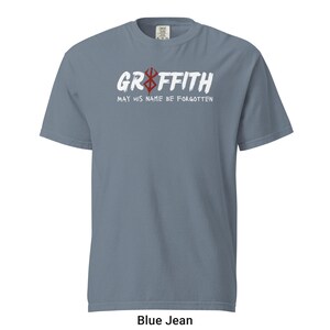 May include: A blue jean t-shirt with white text that reads "Griffith May His Name Be Forgotten" and a red and white symbol.