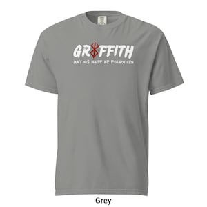 May include: A grey t-shirt with a white graphic print that says "Griffith May His Name Be Forgotten" and a red symbol.