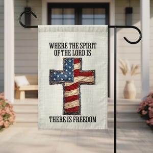 May include: A garden flag with the text "WHERE THE SPIRIT OF THE LORD IS THERE IS FREEDOM." The flag features a cross design with the American flag pattern. The cross is red, white, and blue with a denim-like border.