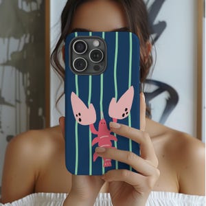 May include: A navy blue phone case with a lobster design. The case features a repeating pattern of vertical light green stripes. The lobster is pink with black dots and is centered on the case.