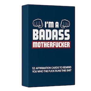 May include: A navy blue box of affirmation cards. The text on the box reads "I'M A BADASS MOTHERFUCKER" in white and red lettering. The box also states "52 AFFIRMATION CARDS TO REMIND YOU WHO THE FUCK RUNS THIS SHIT."