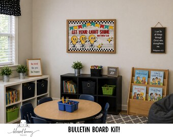 May include: A classroom scene with a round table, chairs, and a bulletin board that reads "Let Your Light Shine." Other decor includes a bookshelf with books, a sign that says "Choose Joy," and a sign that says "Be kind, Be you, Be happy."