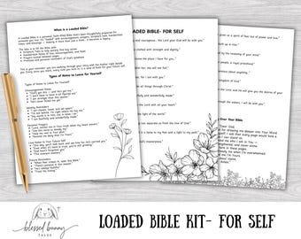 May include: A Loaded Bible Kit for Self, featuring three white pages with printed text and floral illustrations. A gold pen rests on the side. The kit includes notes and prayers. The words "Loaded Bible Kit - For Self" are printed at the bottom.