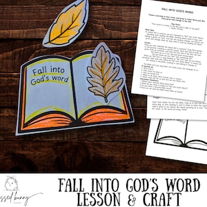 May include: A craft project with the text "Fall into God's Word" on a paper book, accompanied by leaf cutouts and printed lesson sheets. The image has a wooden background and features the text "Fall into God's Word Lesson & Craft".