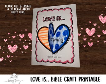 May include: A printable Bible craft with the text "LOVE IS..." and "forgiving" inside a heart shape. The heart is colored orange and blue, with a pink scalloped border. The text "COLOR, CUT & CREATE A 3D HEART ABOUT GOD'S LOVE" is at the top.
