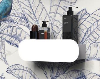 May include: A white wall-mounted bathroom shelf with rounded edges, holding three dark bottles. Below the shelf is a matte black wall-mounted faucet and a white basin. The wall features a blue and white botanical pattern with tropical birds.