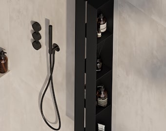 May include: A matte black vertical shower storage unit with four open shelves containing various bottles and tubes. Next to the unit is a black handheld shower head with a flexible hose and three circular black wall-mounted control knobs.