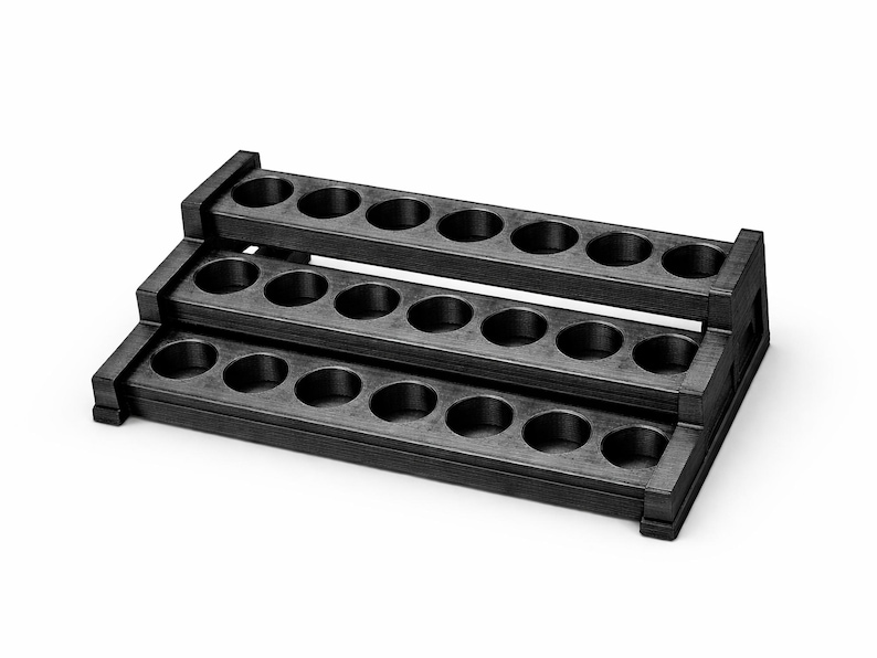 May include: A three-tiered, black wooden display stand with multiple circular openings on each level. The stand is designed for displaying small items, with a simple, functional design. The stand is made of wood.