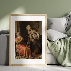May include: A framed print of a classic painting depicting two figures in a rustic interior. One figure, an older man in a red robe, is seated with hands clasped in prayer. A woman holds a lamb, with a dog nearby.