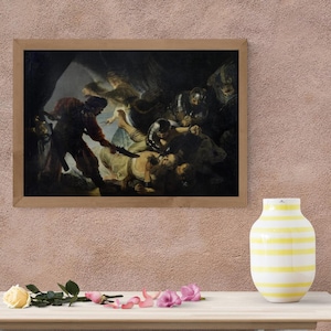 May include: A framed painting depicting a dramatic scene with figures in historical attire. The artwork features a central figure being attacked, surrounded by other characters in a dimly lit setting. The frame is a light brown color.