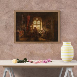 May include: A framed painting depicting a scene with three figures in a room with a window. The painting has a warm color palette, with reds, browns, and yellows dominating the scene. A vase with yellow stripes sits on a table in front of the painting.