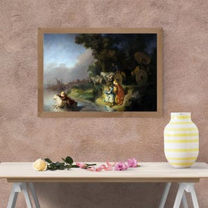 May include: A framed print of a classical painting depicting a scene with figures, horses, and a chariot near a body of water. The artwork features a muted color palette with a focus on light and shadow, set against a backdrop of trees and a cloudy sky.