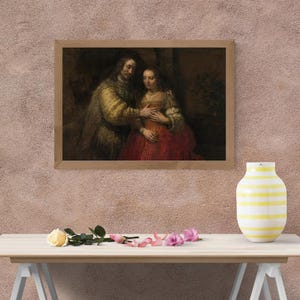 May include: A framed painting depicts a man and woman in a classic style. The man wears a gold and brown patterned coat, while the woman is in a red dress. The artwork is displayed on a pink textured wall.
