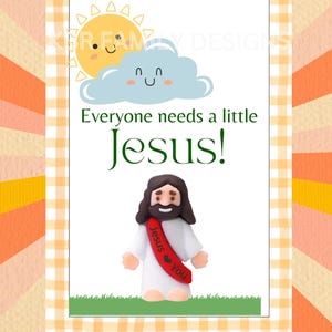 May include: A framed print with a cheerful design. The image features a smiling sun and cloud above the words "Everyone needs a little Jesus!" A small figurine of Jesus with a red sash that says "Jesus loves You" is at the bottom.