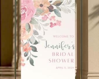 Könnte beinhalten: Ein weißes Schild mit einem Aquarell-Blumenmuster in Rosa-, Pfirsich- und Grüntönen. Das Schild lautet "Willkommen zu Jennifers Bridal Shower am 5. April 2024".