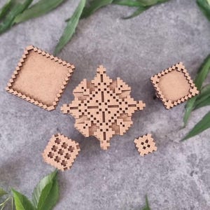 May include: A collection of laser-cut wooden coasters and decorative pieces. The set includes a large snowflake design, two square coasters with a zig-zag edge, and two smaller square pieces. The items are made of light brown wood.