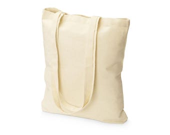 May include: A blank canvas tote bag made of a light beige fabric. The bag has two long straps for carrying over the shoulder and is empty. The bag is a simple, reusable shopping bag.