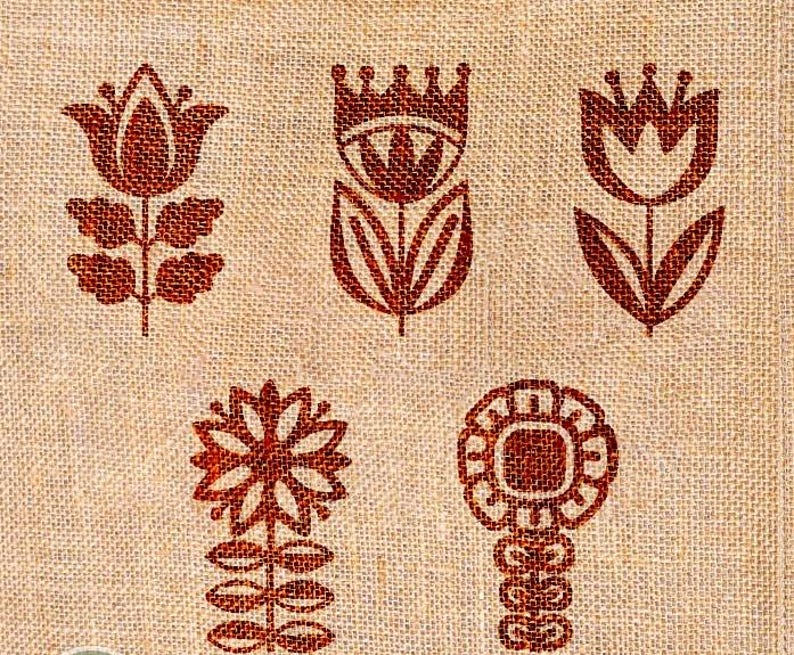 May include: Close-up of a beige fabric featuring a repeating pattern of reddish-brown floral designs. The flowers are stylized, with shapes including tulips and other geometric forms. The fabric has a textured appearance.