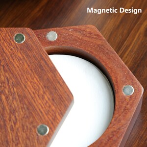May include: Close-up of a wooden box with a hexagonal design and a magnetic closure. The box is made of reddish-brown wood and has silver magnets. The text "Magnetic Design" is visible.