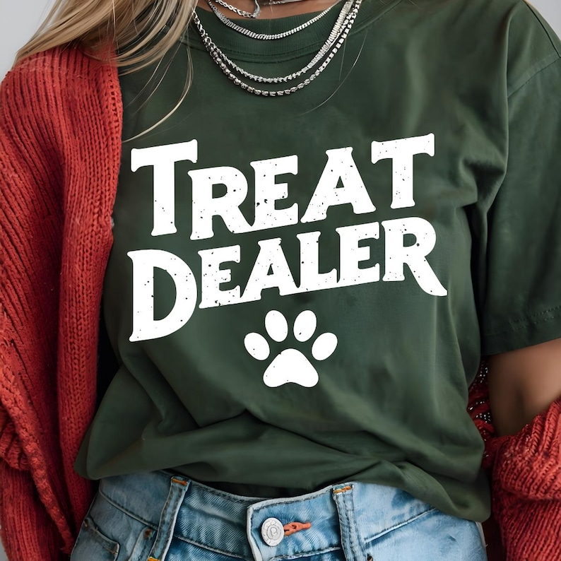 May include: A green t-shirt with the text "Treat Dealer" in white with a white paw print below the text.