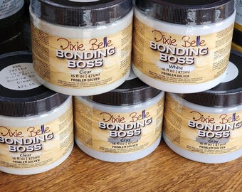 May include: A stack of Dixie Belle Bonding BOSS jars, each with a black lid and a label that reads "Clear", "White", or "Gray". Each jar contains 16 fl oz (473ml) of a problem solver.