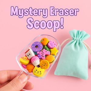 May include: A clear scoop filled with colorful erasers in various shapes, including a donut, star, and cat face, next to a light green drawstring bag. The text "Mystery Eraser Scoop!" is displayed in purple above the scoop.