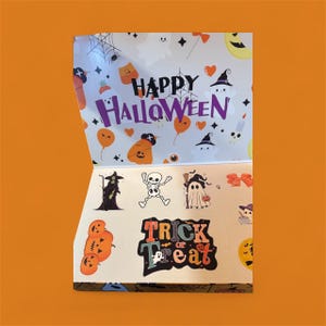May include: A Halloween-themed sticker sheet with various designs. The top section reads "Happy Halloween" in purple, with illustrations of ghosts, pumpkins, and bats. The bottom section features stickers of a witch, skeleton, ghost, and the words "Trick or Treat".