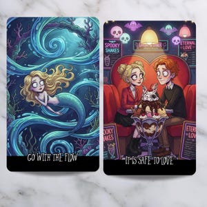 May include: Two rectangular cards with illustrations. The left card shows a blonde mermaid in blue water with the text "GO WITH THE FLOW". The right card shows two people in a diner booth with a large sundae and the text "IT IS SAFE TO LOVE".