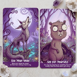 May include: Two rectangular oracle cards with purple-toned illustrations. The left card shows a wolf howling at a moon with the text 'Use Your Voice'. The right card features a groundhog-like creature in a forest with the text 'See for Yourself'.