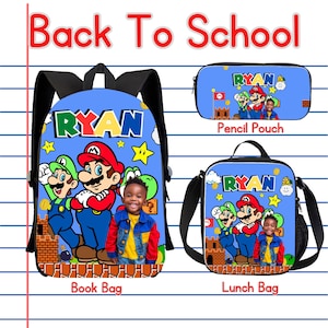 May include: A blue backpack, lunch bag, and pencil pouch set featuring the text Back To School, Ryan, and graphics of Mario, Luigi, and Yoshi. Each item displays a photograph of a young child wearing a denim jacket and a yellow shirt.