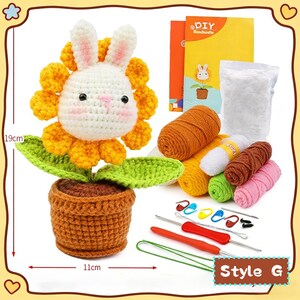 May include: A crochet kit featuring a bunny-shaped flower with yellow petals, green leaves, and a brown pot. The kit includes yarn in various colors, crochet hooks, and a DIY booklet. The flower measures 19cm tall and the pot is 11cm wide.