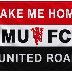 May include: A rectangular horizontal flag featuring three equal horizontal stripes in red, white, and black. The top red stripe displays the white text TAKE ME HOME. The middle white stripe features the black text MU FC with a red devil emblem in the center. The bottom black stripe displays the white text UNITED ROAD. The flag includes four gold metal grommets at the corners.