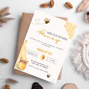 May include: A bridal shower invitation with the text "She Found Her Honey" and a bee illustration. The invitation includes the honoree's name, date, time, and RSVP information. The design features watercolor honeycombs and a honey pot.
