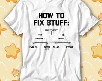 May include: White t-shirt with the text "HOW TO FIX STUFF:" in black. Below the title is a flowchart with the question "DOES IT MOVE?" and various solutions like "GAFFER TAPE" and "OIL-40".