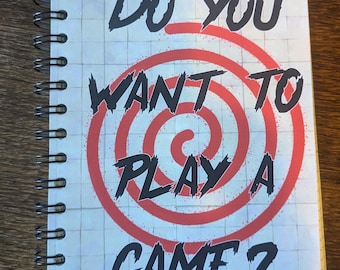 Saw inspired notebook with grid paper pages.