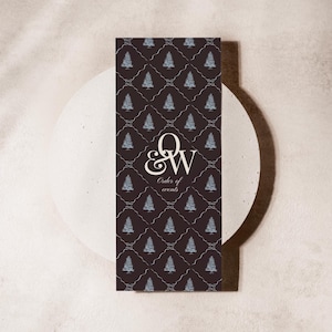 May include: A rectangular order of events card with a dark brown background and a repeating pattern of light blue Christmas trees. The card features the letters "Q & W" in a decorative font, with the words "Order of events" below.