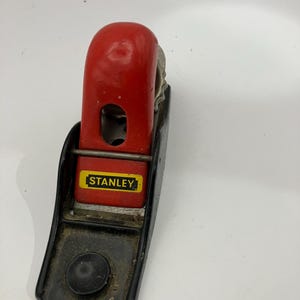 May include: A set of three ceramic mugs with a speckled, matte finish. The mugs are in shades of cream, light gray, and dark gray. Each mug has a simple, minimalist design and a rounded handle.