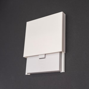 May include: A white rectangular box with a hinged lid. The lid is open and the box is empty.