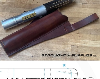 May include: A brown leather holster with a strap for a lightsaber. The lightsaber is silver with a brown wooden handle and gold accents. The text "STARLIGHT SUPPLIES CO." is visible in the bottom right corner of the image. The image also includes the text "A4 & LETTER DIGITAL FILE" and a PDF icon.