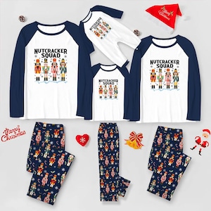 May include: A collection of matching family Christmas pajamas. The tops are white with navy blue sleeves and feature a "Nutcracker Squad" graphic. The pajama pants are navy blue with a nutcracker print. A red Santa hat is also included.