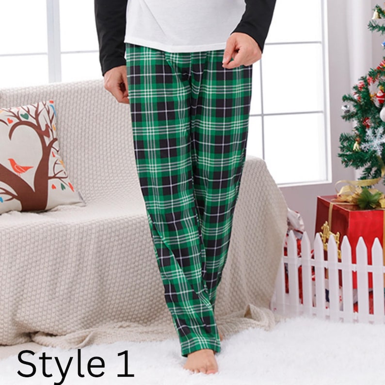 May include: Green and black plaid pajama pants. The pants are part of a pajama set, paired with a white top and black sleeves. The text "Style 1" is at the bottom of the image. The pants are made of a soft, comfortable material.