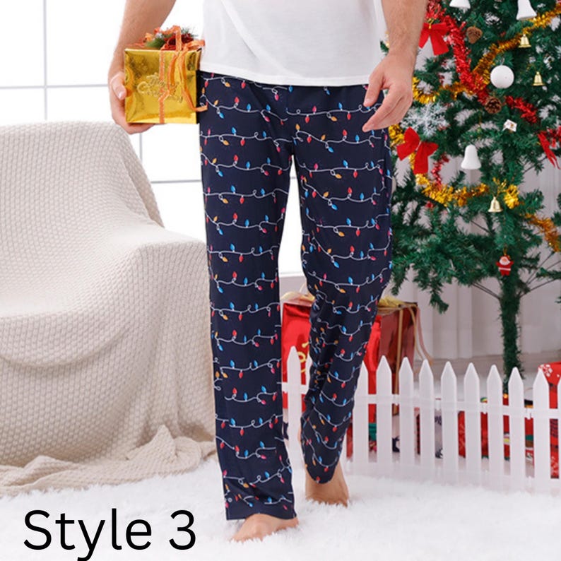 May include: Navy blue pajama pants with a repeating pattern of colorful Christmas lights. The pants are part of a holiday-themed collection. The text "Style 3" is visible at the bottom of the image.