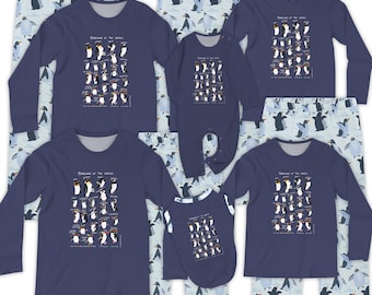 May include: Navy blue long-sleeved shirts, a onesie, and a dog shirt, all featuring a penguin chart design. Matching light blue pajama pants with penguin patterns are also included. The text "Penguins of the World" is printed on the shirts.